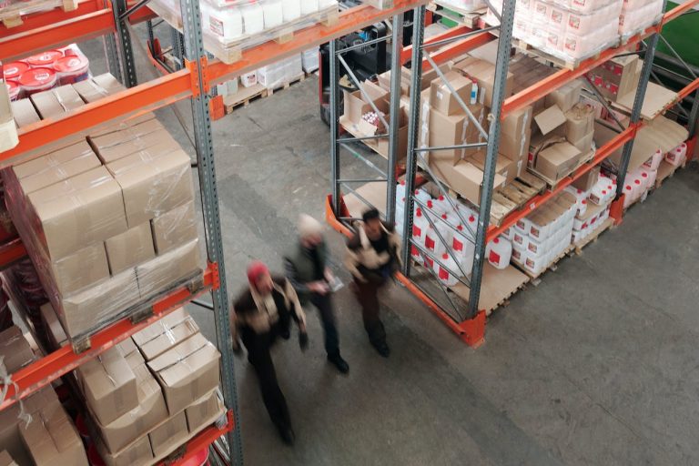 Staff moving through a cargo logistics company storage warehouse. | OneLogix Cargo Solutions