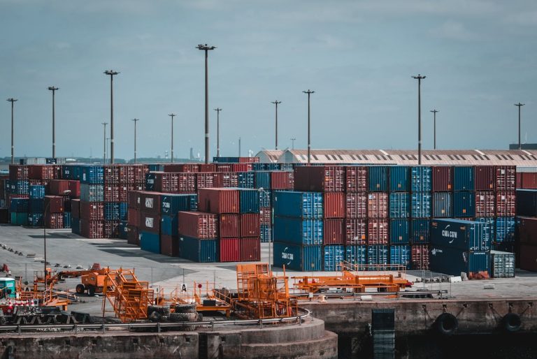 Clearance and Forwarding Yard | Stacked Cargo Containers About To Embark in Clearance and Forwarding | OneLogix Cargo Solutions